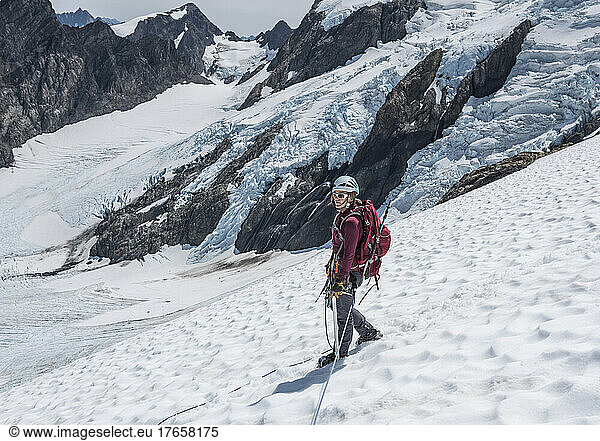 A woman walks down the Blue Glacier on Mount Olympus