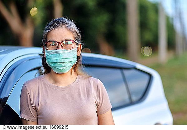 A women wear a mask during after road trip during COVID-19 epidemic