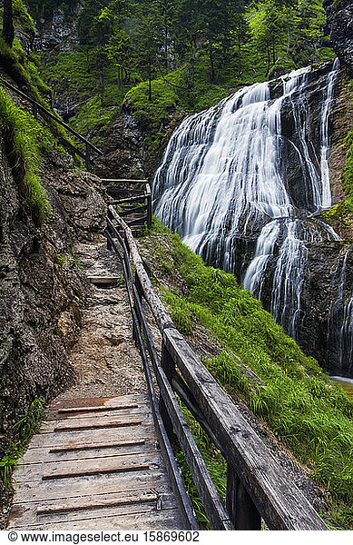 A wooden walkway leading to the Wasserlochklamm waterfall cascades in the Austrian Alps  long exposure; Landl  Austria