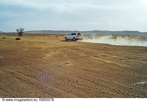 A 4x4 car at high speed through the desert of Morocco