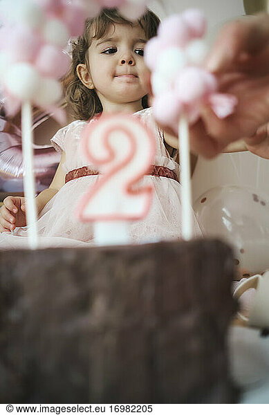 A 2 year old girl celebrating her birthday