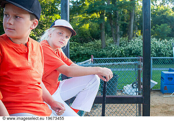 A 10 year old girl in dugout with team