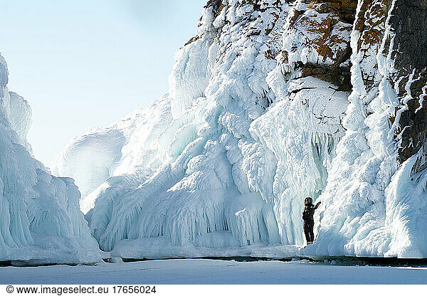A 40-year-old woman stands on an icy rock  Baikal