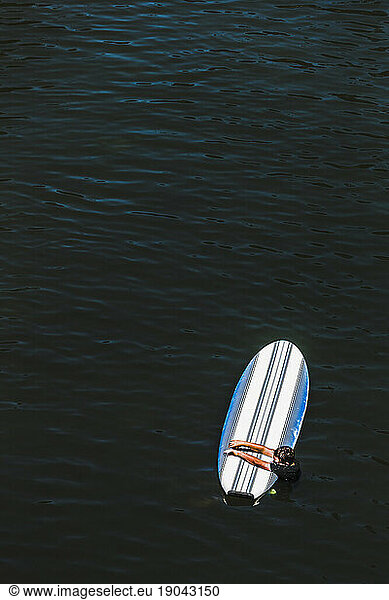 A Young Boy Holding Onto A Paddleboard On The Russian River