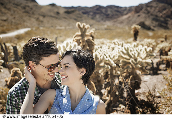 A young couple  man and woman in a desert landscape.