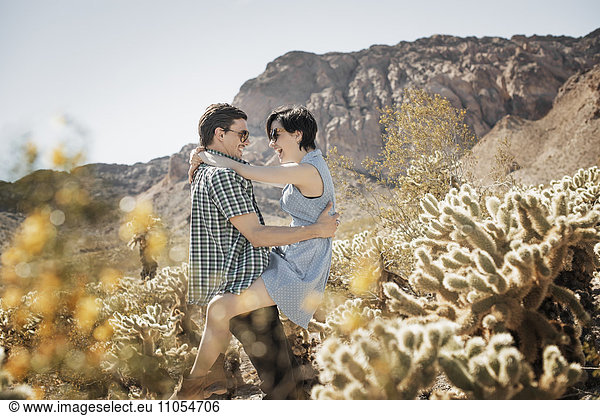 A young couple  man and woman in a desert landscape.