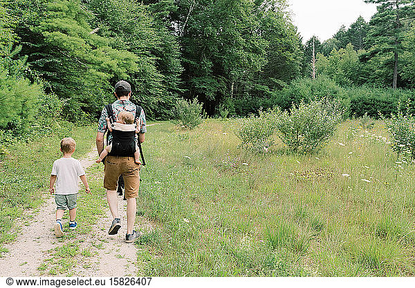 A young family and their dog on a nature walk.