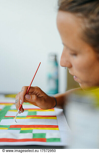 A young girl making art with colors