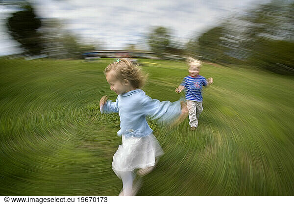 A young girl runs from a young boy in grass  Newcastle  California. (Motion Blur)