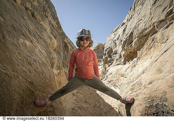 A young girl smiling in a slot canyon in the desert