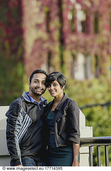 A Young Indian Ethnicity Couple Poses In Front Of The Fairmont Empress Hotel In Autumn; Victoria  Vancouver Island  British Columbia