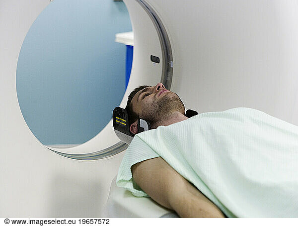 A young man about to have an MRI scan.