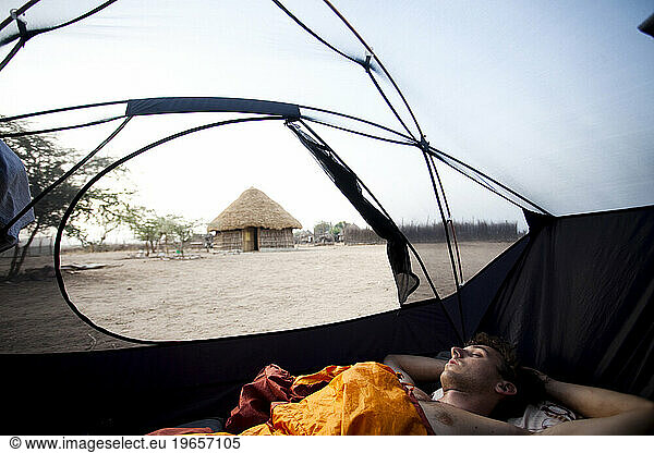 A young man sleeps in a tent near the village of Karo in southern Ethiopia.