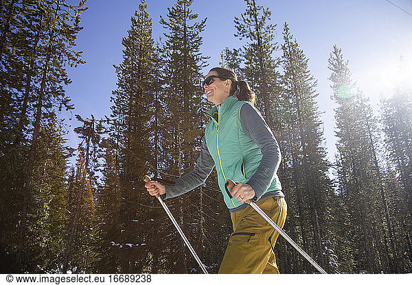 A young woman cross-country skis on a sunny day near Mt. Hood.