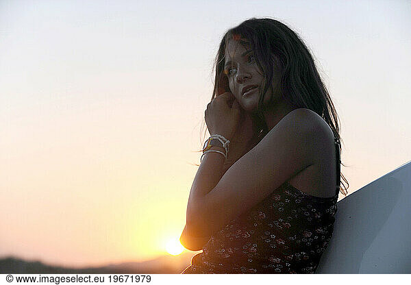 A young woman enjoys a Spanish sunset.