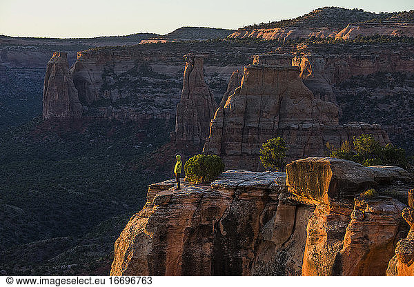 A young woman enjoys a view over Colorado National Monument in CO.