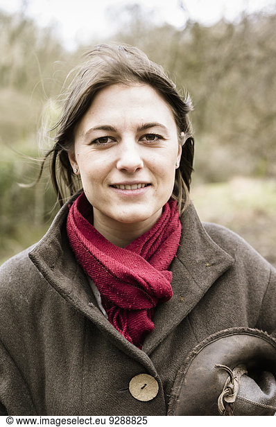 A young woman in a scarf and outdoor coat.