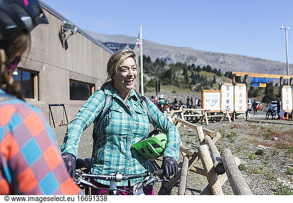A young woman laughs during a rest at Timberline Bike park in Oregon.