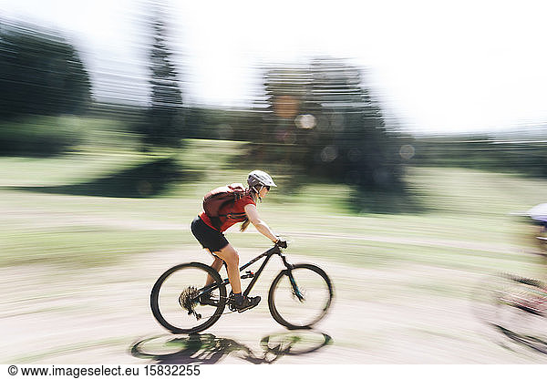 A young woman rides her mountain bike near Mount Hood  Oregon.