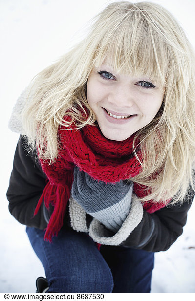 A young woman with blond hair in the snow.