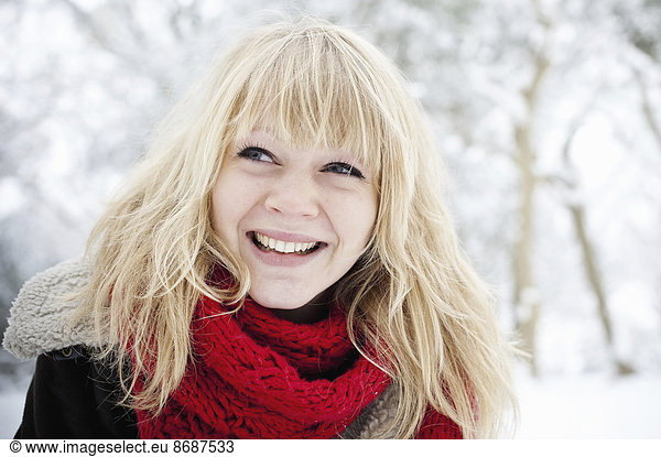 A young woman with blond hair in the snow.