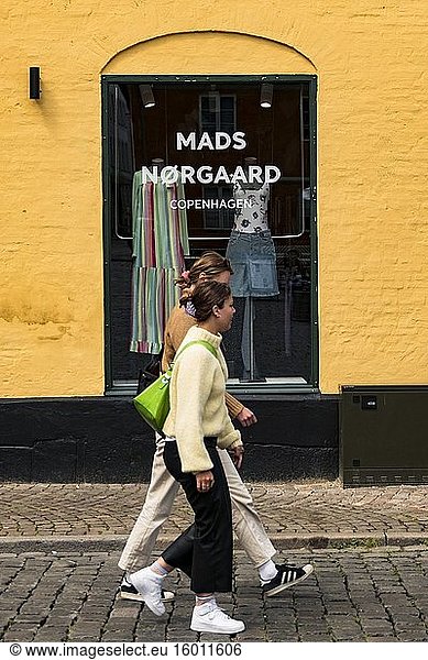 Aarhus  Denmark June 8  2020 Well-dressed women walking in old town in front of a boutique.