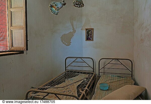 Abandoned bedroom with two beds and open window  lost place  unoccupied house  bedchamber  bedroom  marriage beds  double beds  single beds  metal beds  Spain  Europe