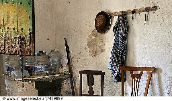 Abandoned finca as a workroom with chairs and wardrobe  hat and shirt on coat hooks  Lost Place  Andalusia  Spain  Europe