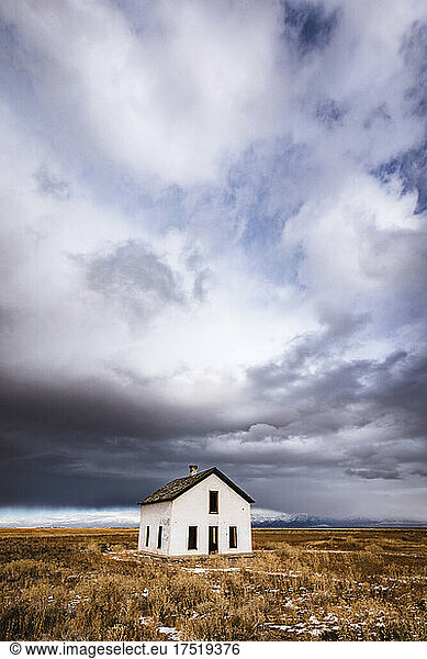 Abandoned house in lonely isolated desert with clouds  Colorado