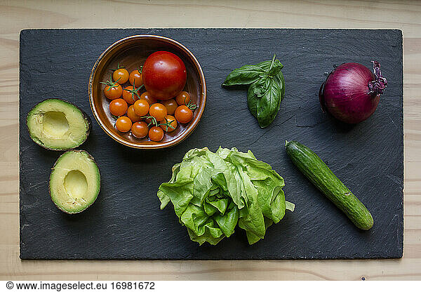 Above-view of colorful fresh vegetables arrayed on a cutting board