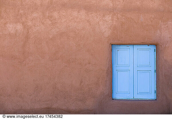 Abstract image of blue window and red adobe wall  Taos  New Mexico