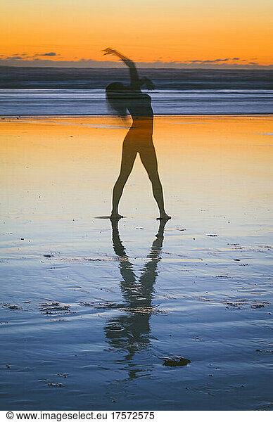 Abstract of a naked female on the beach at sunset