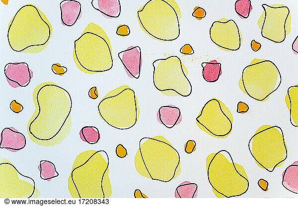 Abstract yellow and pink watercolor painting on white paper