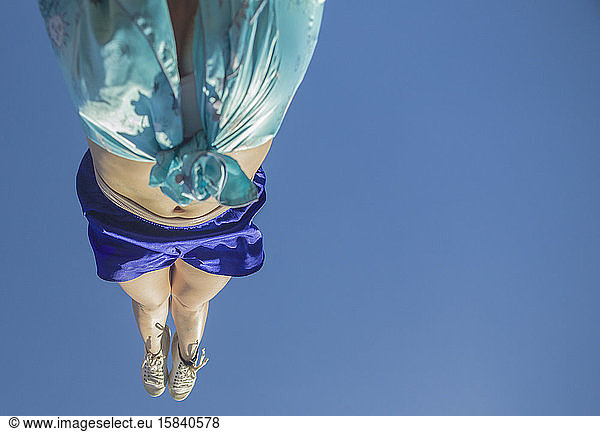 Acrobat do a handstand wearing cetim clothes during Rio Carnival