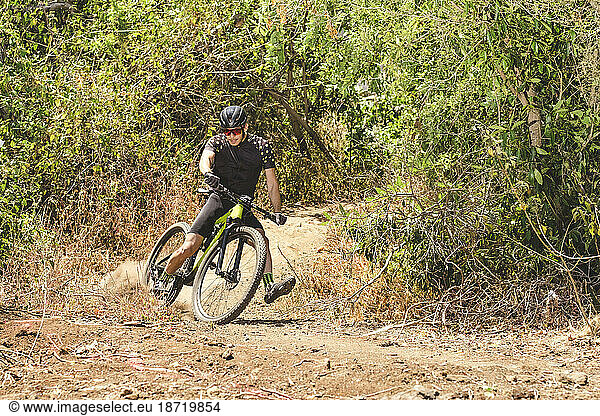 Action photo of male mountain bike cyclist on trail