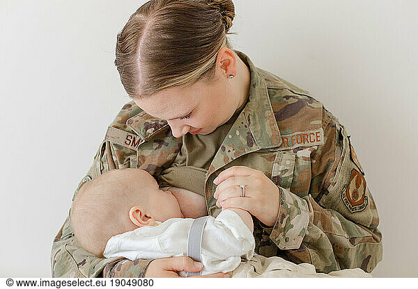 active duty air force airman breastfeeds her baby while in uniform