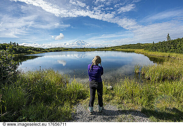Active Woman looking at Denali in Alaska