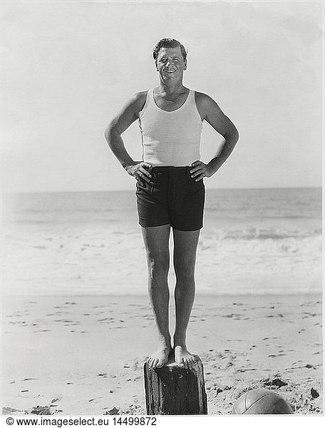Actor George Bancroft  Portrait Standing on Wood Post at Beach  Santa Monica  California  USA  1930's