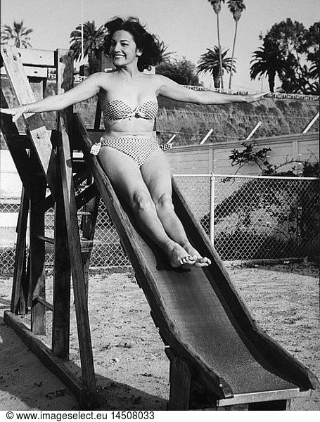 Actress Charlita  Publicity Portrait on Slide in Two-Piece Bathing Suit  1955
