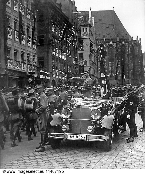Adolf Hitler (1889-1945) Austrian-born German Chancellor  standing in a car taking the salute at a parade of SA troops  Nuremberg  1935. Nazi Fascist