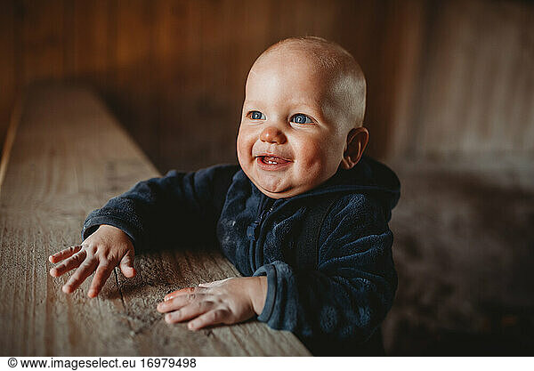 Adorable little boy with blue eyes smiling wearing a jacket