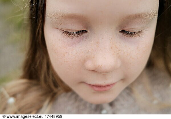 Adorable little girl with freckled face