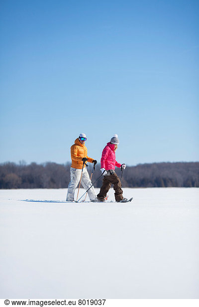 Adult couple walking on snow
