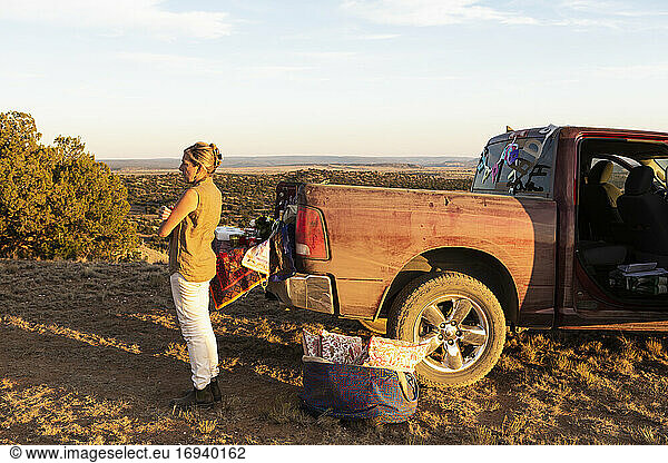 adult woman next to dirty pickup truck  Galisteo Basin