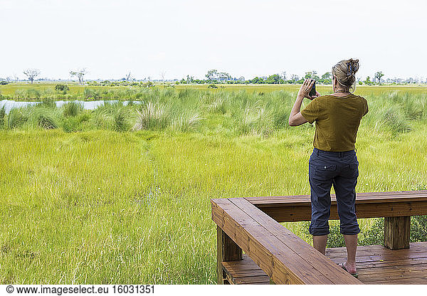adult woman photographing scenic landscape  Botswana