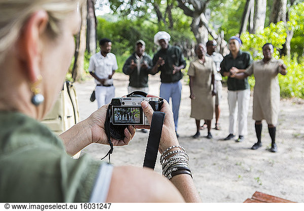 adult woman taking pictures of tented camp staff  Botswana