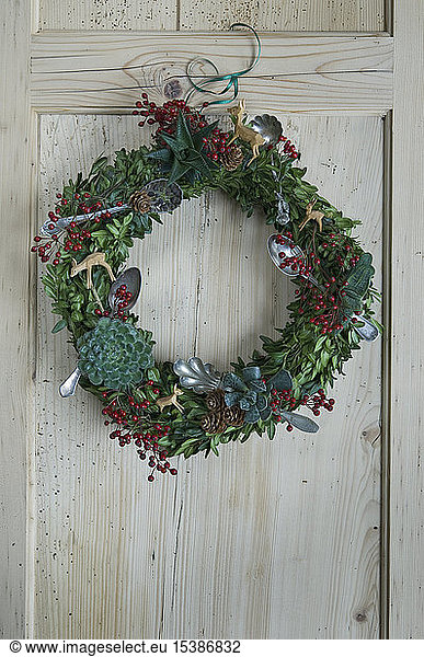Advent wreath hanging at wooden door