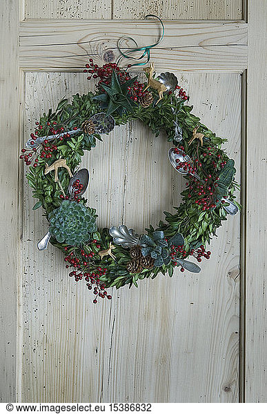 Adventskranz an Holztür hängend
