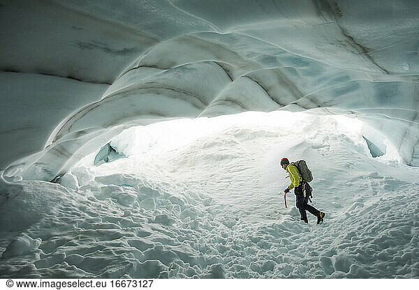 Adventurous explorer hikes though glacial ice cave near Vancouver  B.C