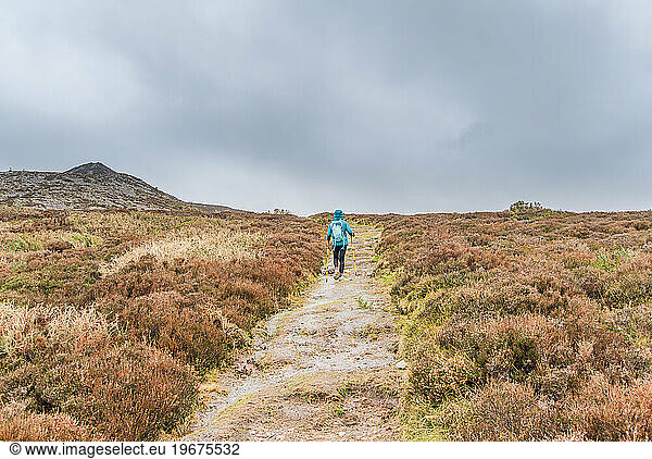 Adventurous Woman Hiking Rain-Soaked Trail